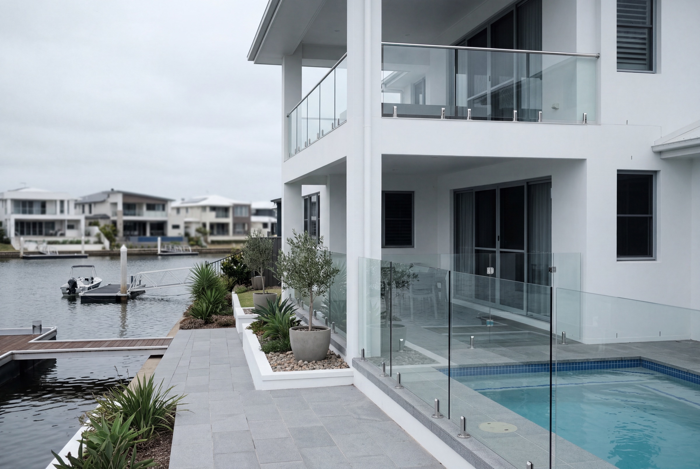 Canal-front home maintained on the Salt Maintenance Pack, with crystal-clear glass balustrades and polished stainless fittings